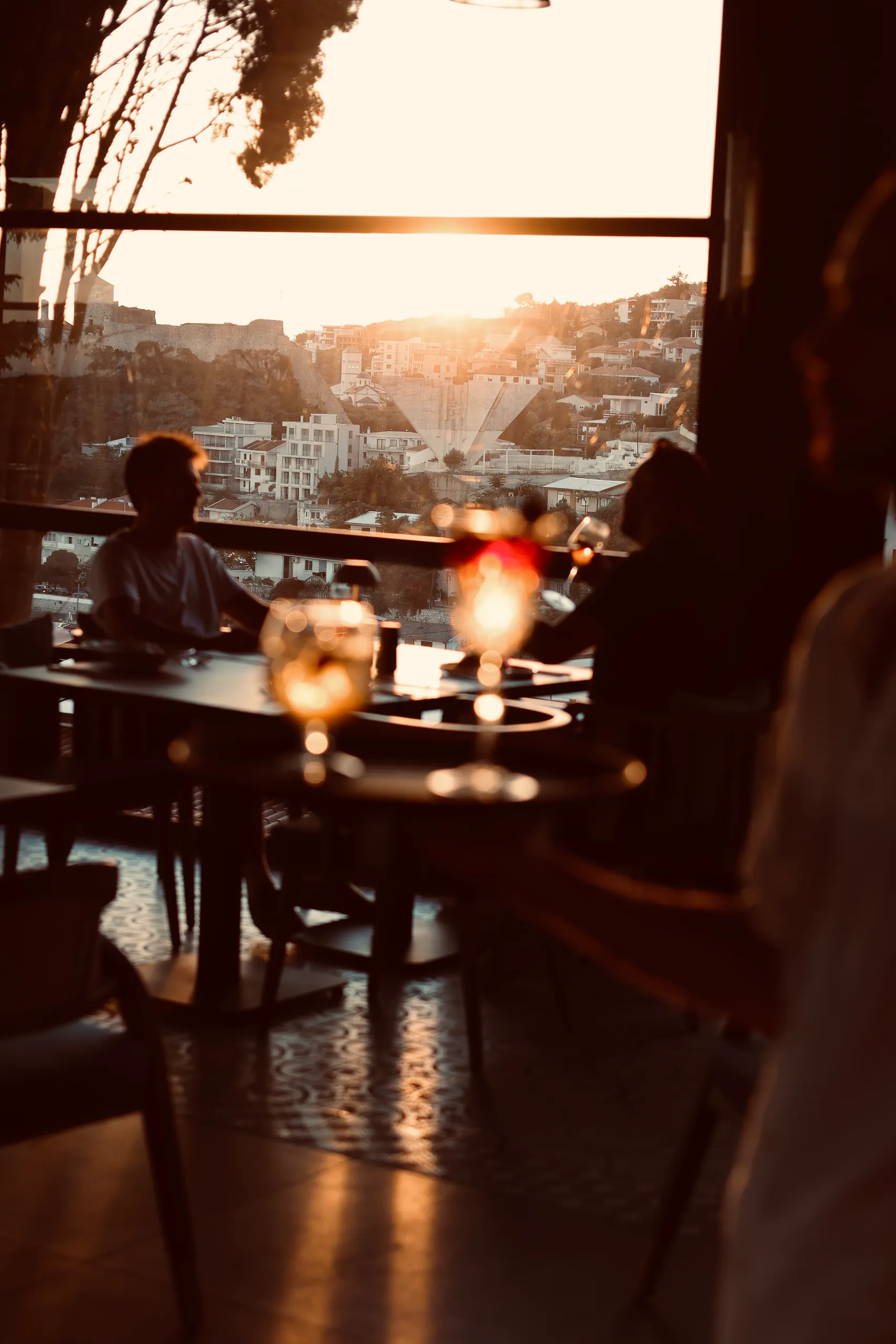 The KALO dining room open to the Adriatic at dusk.